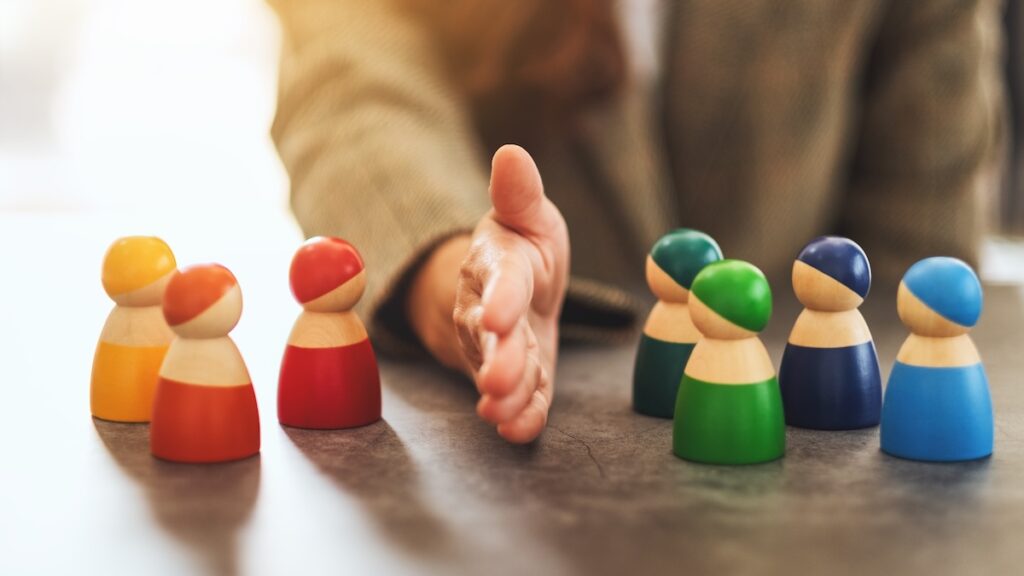 Concept image of a business woman separate wooden people into two group